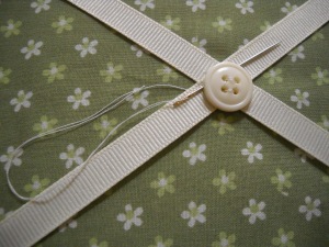 When knotting, catch the needle through some ribbon underneath the ribbon. Notice the loop.